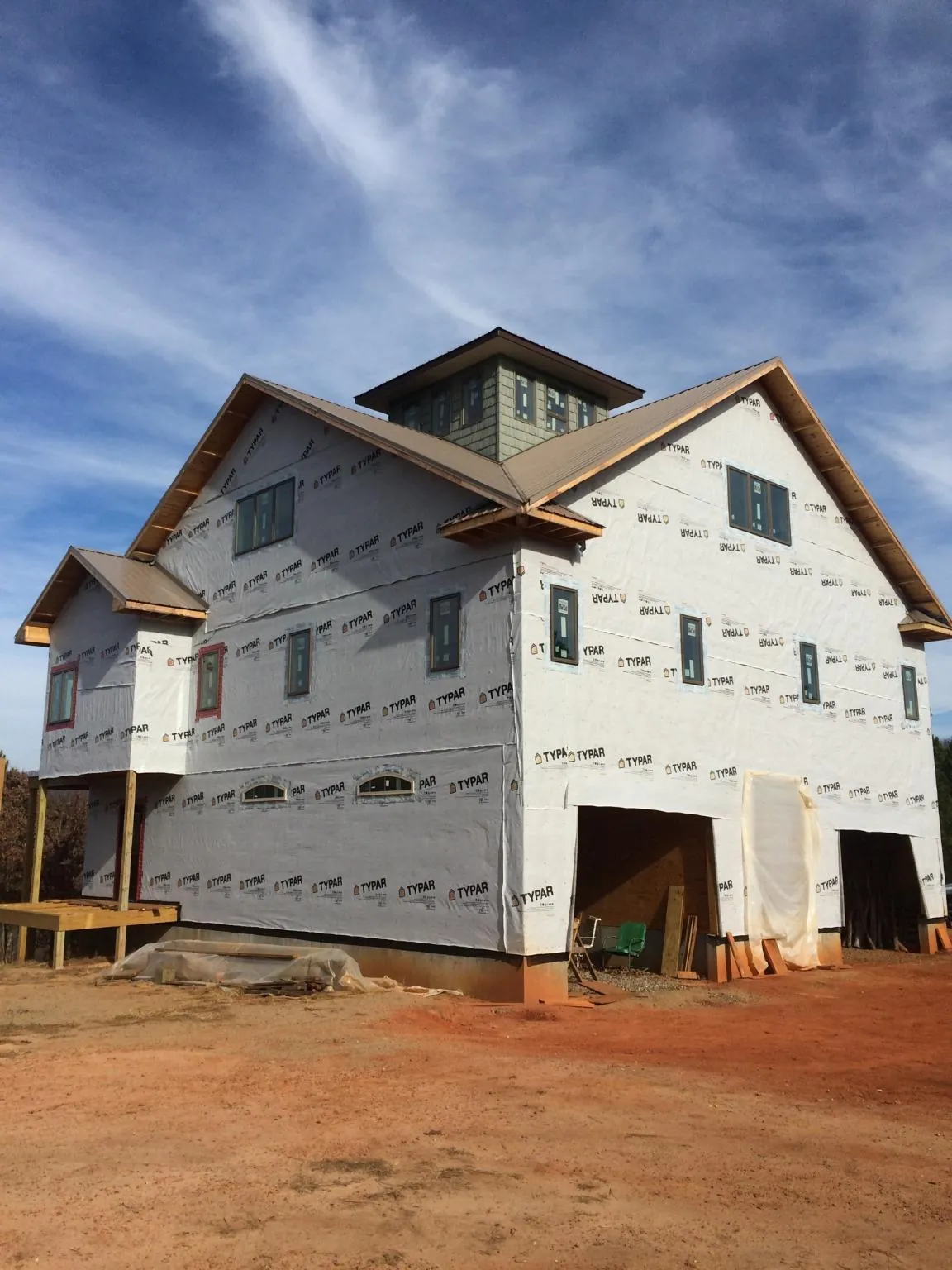New two story house under construction with a cupola and gabled roofs in Millington